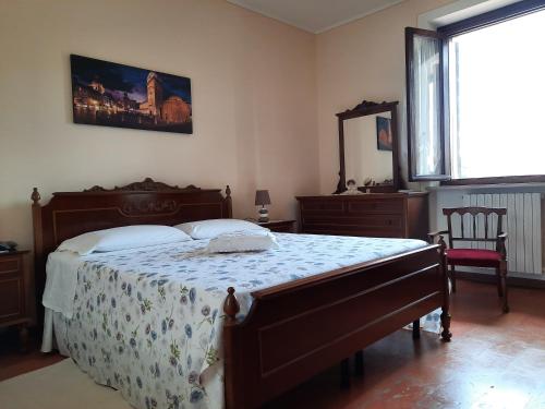 a bedroom with a bed and a mirror and a window at CORTE MORONA in Marmirolo
