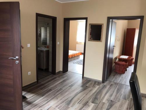 a room with a hallway with two doors and a bedroom at Adrienn Apartman in Sárvár