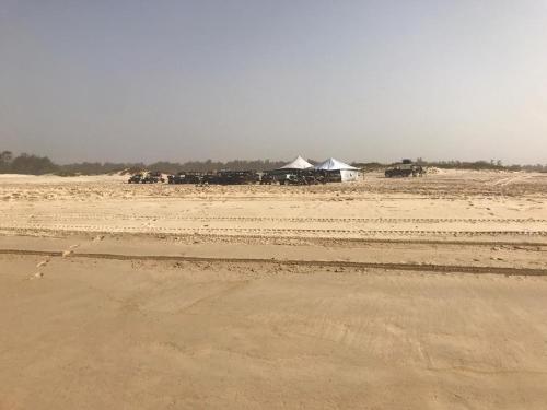 a group of animals in a desert with tents at Hotel le Trarza in Niaga