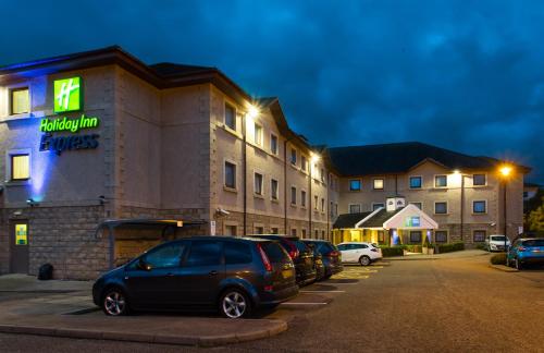 a parking lot in front of a hotel at night at Holiday Inn Express Inverness, an IHG Hotel in Inverness