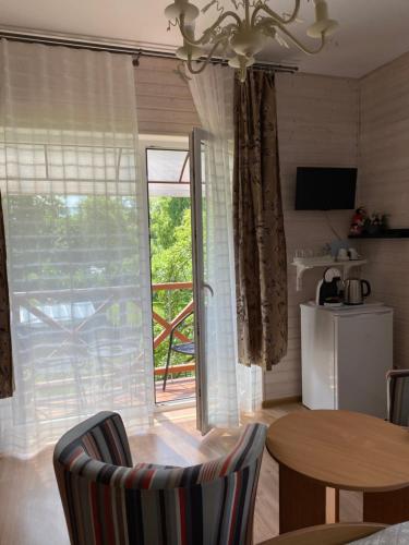 a kitchen with a table and a door to a patio at Green Gile Villa in Druskininkai Center in Druskininkai
