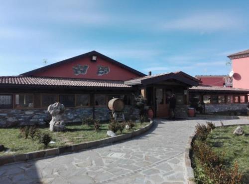 a large building with a courtyard in front of it at I fiori del Pollino - Guest House in San Severino Lucano