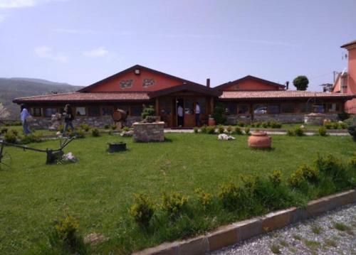 a house with a yard in front of it at I fiori del Pollino - Guest House in San Severino Lucano