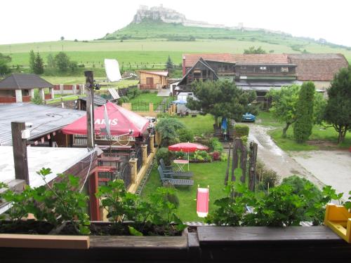 a view of a village with a castle in the background at A+S Penzion Podzamok in Spišské Podhradie