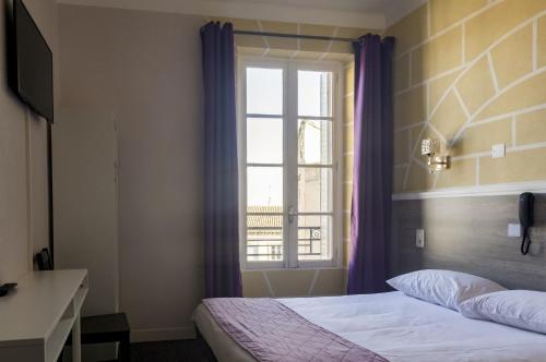 Katil atau katil-katil dalam bilik di Citotel Hôtel Cesar