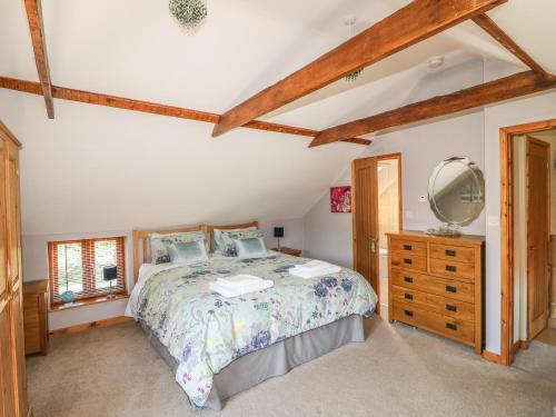 a bedroom with a bed and a dresser and a mirror at Fair Lea Barn in Lincoln