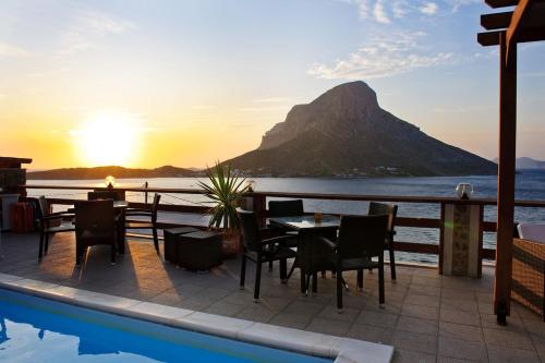 a restaurant with a view of a mountain at Kalymnos Village in Masouri