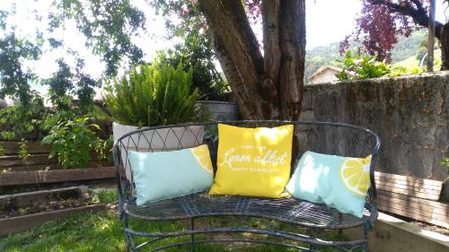a metal bench with three pillows on it at Txantxorena in Zubiri