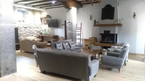 a living room filled with furniture and a fireplace at Txantxorena in Zubiri
