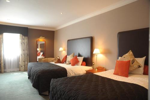 A bed or beds in a room at The Moat House 