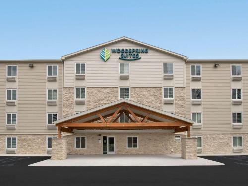a large building with a sign on top of it at WoodSpring Suites Atlanta Conyers in Conyers
