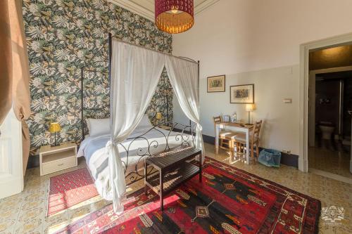 a bedroom with a large bed and a large window at B&B Grand Tour Catania in Catania