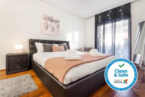 a bedroom with a large bed in a room at Pink Apartment - Spacious Apartment with Pool in Viana do Castelo