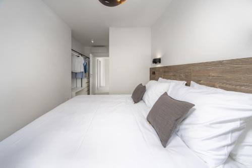 a large white bed with two pillows on it at VILLA FUX ZRCE Novalja - direkt am Strand in Časka