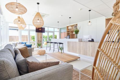 a living room with a couch and a table at Les Terrasses d'Atlanthal in Anglet