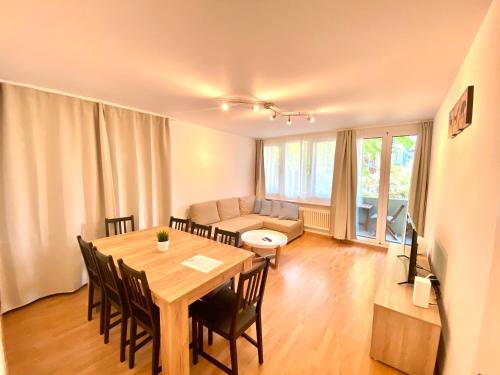 a living room with a dining room table and a couch at Galaxy Apartments Lucerne in Luzern