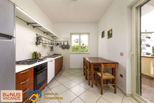 a kitchen with a table and a stove and a sink at Livingapple in Scauri