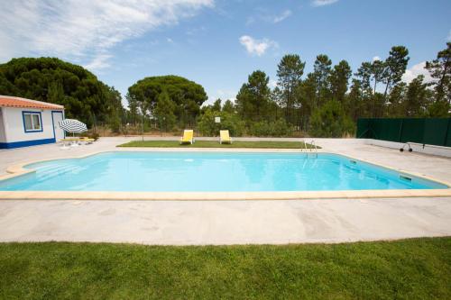 a large swimming pool in a yard at Sossego da Natureza - Monte Alentejano in Grândola