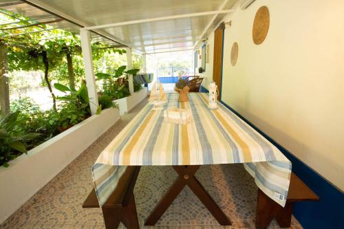 a table with a striped table cloth on top of a room at Sossego da Natureza - Monte Alentejano in Grândola