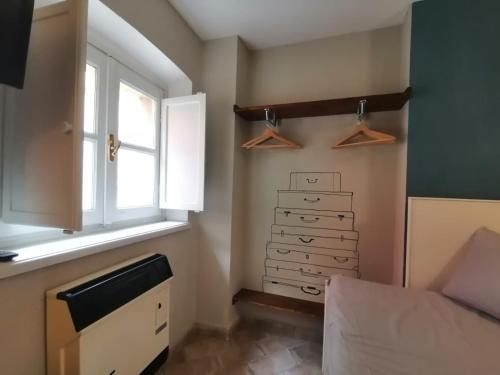 Pokój z łóżkiem, oknem i komodą w obiekcie Romantico bilocale nel cuore del Balon w Turynie