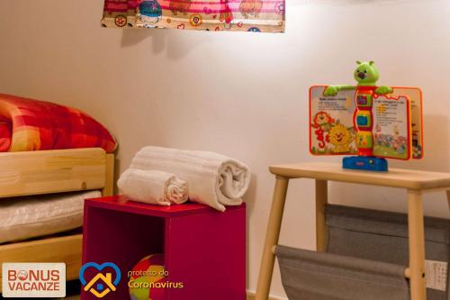 a bedroom with a bed and a table with a towel at Livingapple in Scauri