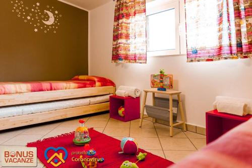 a room with two beds and a red rug at Livingapple in Scauri