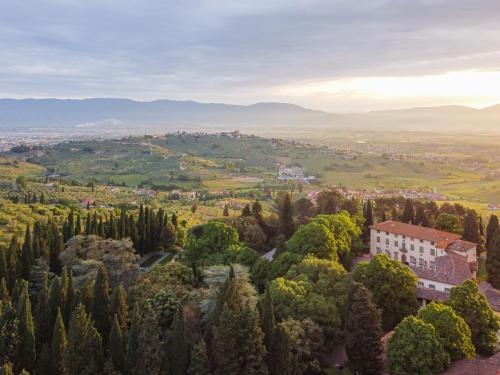 an aerial view of a town with trees and a building at Agriturismo La Fattoria di Capezzana in Carmignano