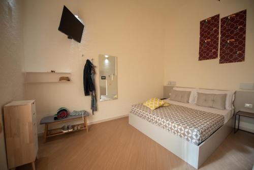 A bed or beds in a room at San Vito Accommodations