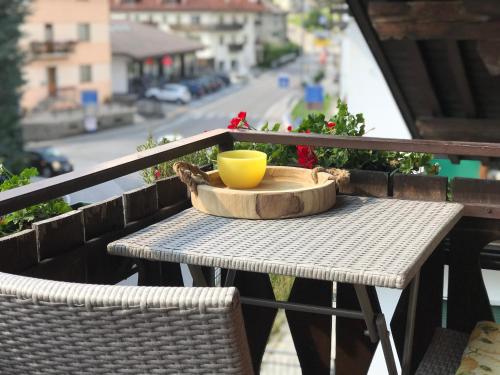 a table with a yellow bowl on it on a balcony at The Bijoux - Dolomites in Agordo