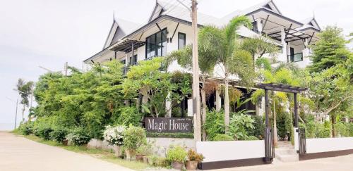 a hotel with a sign in front of a building at Magic House - No Pets Allowed in Chumphon