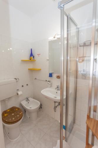 a bathroom with a toilet and a sink and a shower at Stella Marina in Camogli