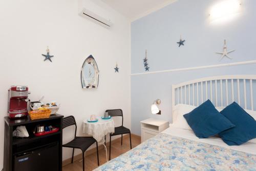 a bedroom with a bed and a table with chairs at Stella Marina in Camogli