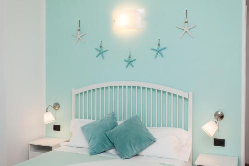 a bedroom with a white bed with stars on the wall at Stella Marina in Camogli