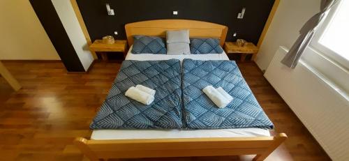 a bed with a blue comforter in a room at Country house Plitvice in Plitvica selo