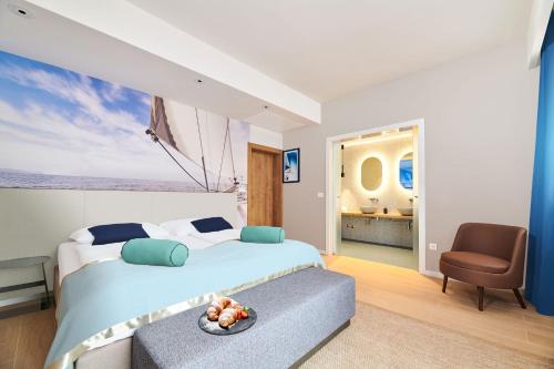 a bedroom with a large bed and a chair at Ribarska Koliba Resort in Pula