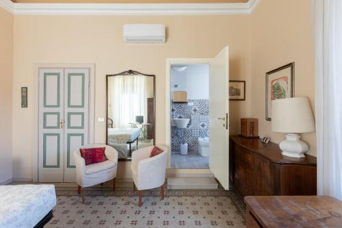 a bedroom with a bed and a bathroom at Attico Luce B&B in Osimo