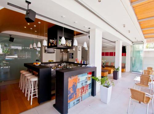 a kitchen with a bar and a dining room at Atlantis Boutique City Hotel in Rhodes Town