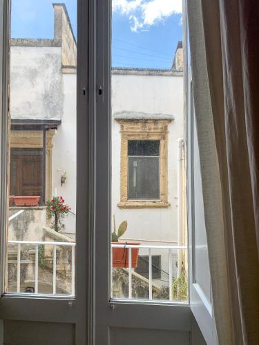 an open window with a view of a building at 4 Balconi rooms-Boutique B&B in Lecce