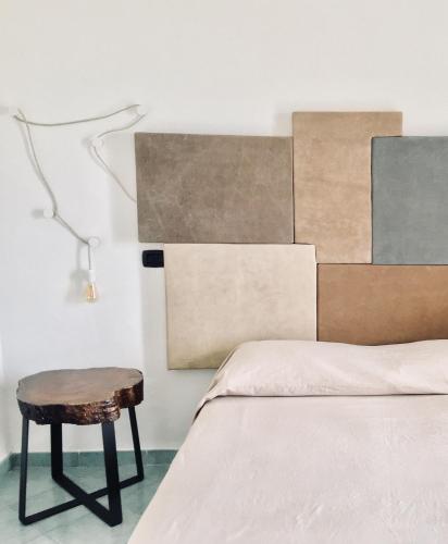 a bedroom with a bed with a stool next to it at Black Market Hotel in Ischia