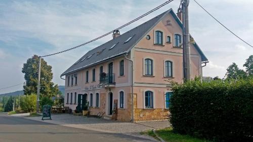 a large building on the side of a street at Na Kopečku AD 1795 - penzion s restaurací a wellness v Podkrkonoší in Dvůr Králové nad Labem