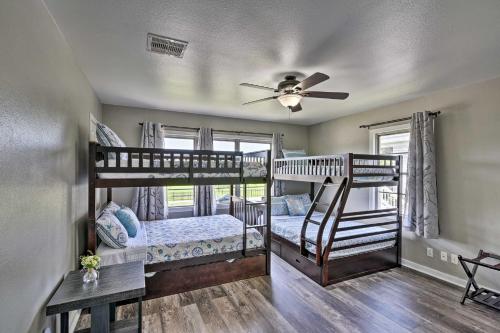 a bedroom with two bunk beds and a ceiling fan at Spacious and Modern Family Duplex in Galveston! in Galveston
