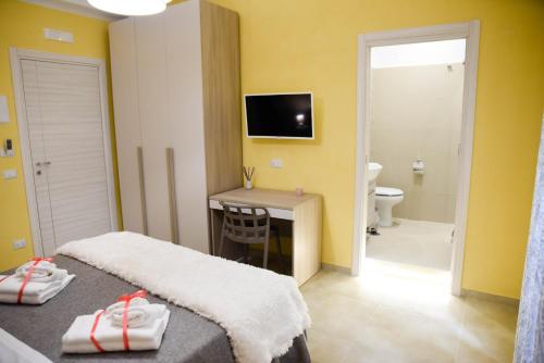 a hotel room with a bed and a bathroom at La Corte di BisMary B&B in Salerno