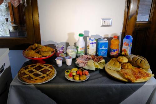 a table topped with different types of food and drinks at B&B La Tana Dei Ricci in Sestola