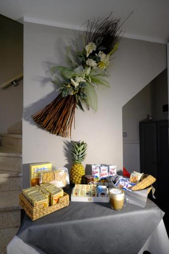 a table topped with food and a vase of flowers at B&B La Tana Dei Ricci in Sestola