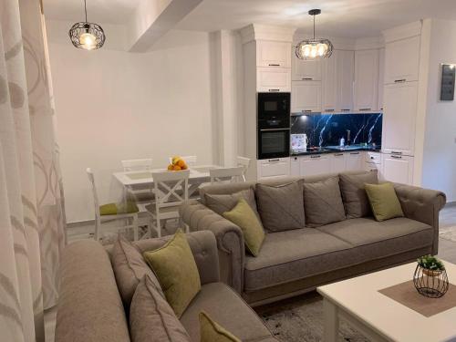 a living room with a couch and a kitchen at Apartment All Seasons in Ulcinj