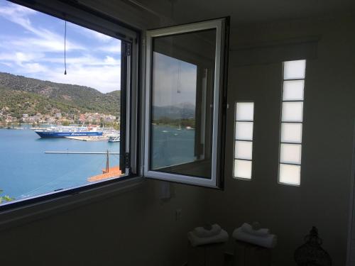 a window with a view of a body of water at Kasteli Suite in Poros