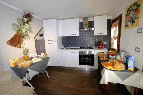 a kitchen with two tables with food on it at B&B La Tana Dei Ricci in Sestola