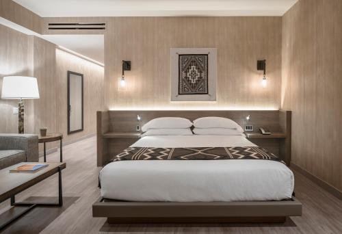 a bedroom with a large bed and a couch at Hotel Chaco in Albuquerque