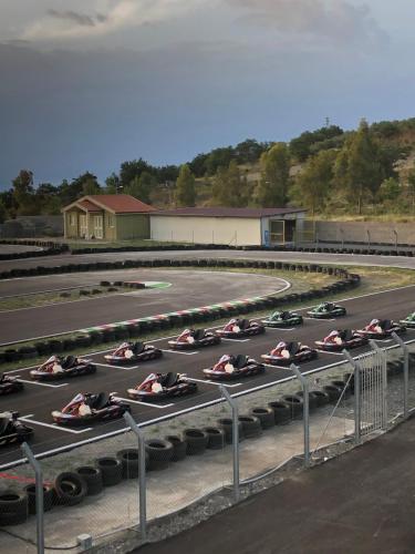 a group of cars parked in a race track at Basicò un balcone sul mare-Casa I CARRUGGI- Case vacanza Sicilia&Toscana- in Basicò