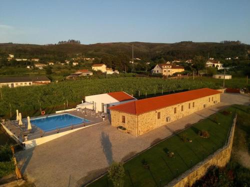 an aerial view of a building with a swimming pool at Quinta de Real in Valença